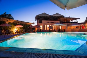 a home at dusk with a swimming pool