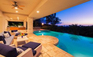 luxury home with swimming pools at dusk