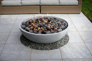 outdoor fire pit in a home's backyard next to some seats