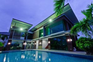 a home with a modern swimming pool at night