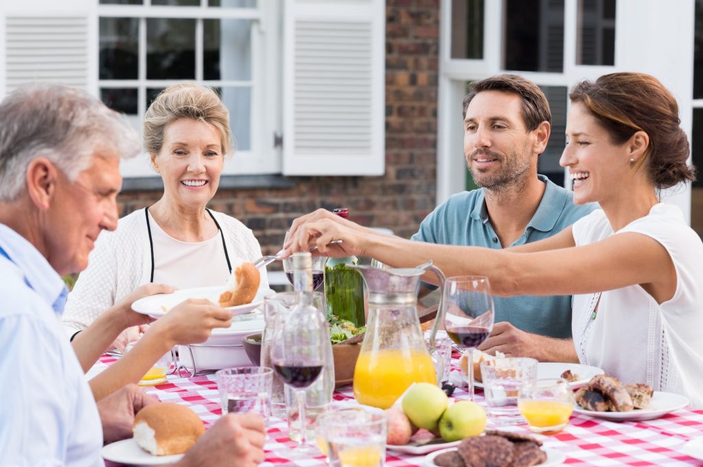 happy family sharing food outside 