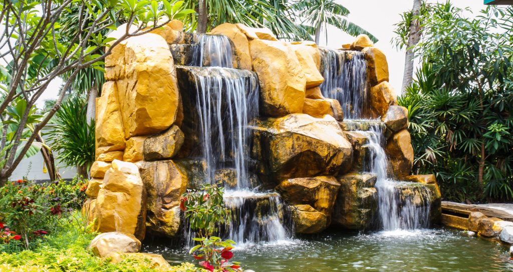 backyard waterfall during a beautiful summer's day