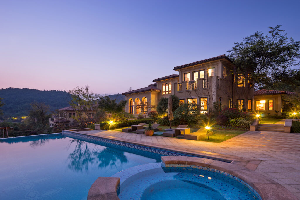 a beautiful pool in a home's backyard at sunset